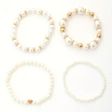 Set of elegant pulseras in shape of corazón with perlas