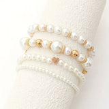Set of elegant pulseras in shape of corazón with perlas